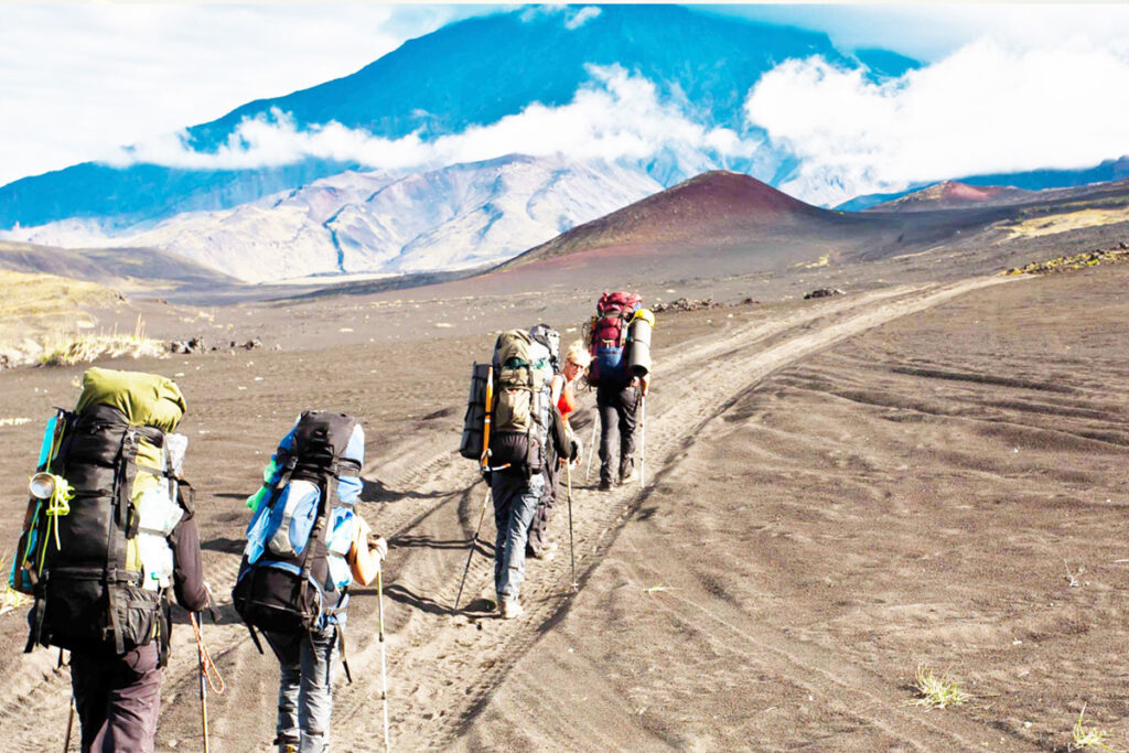 Ol Doinyo Lengai trek with hikers on volcanic trail